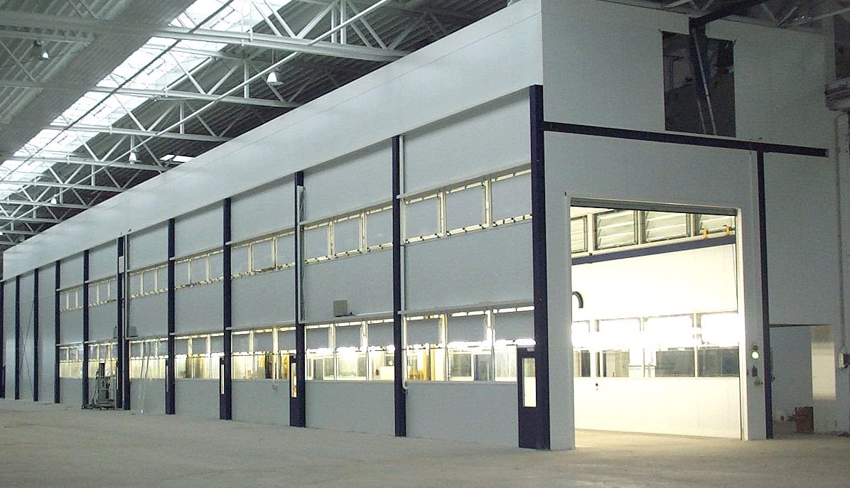 Large enclosed surface-treatment line with metal-frame partitions.