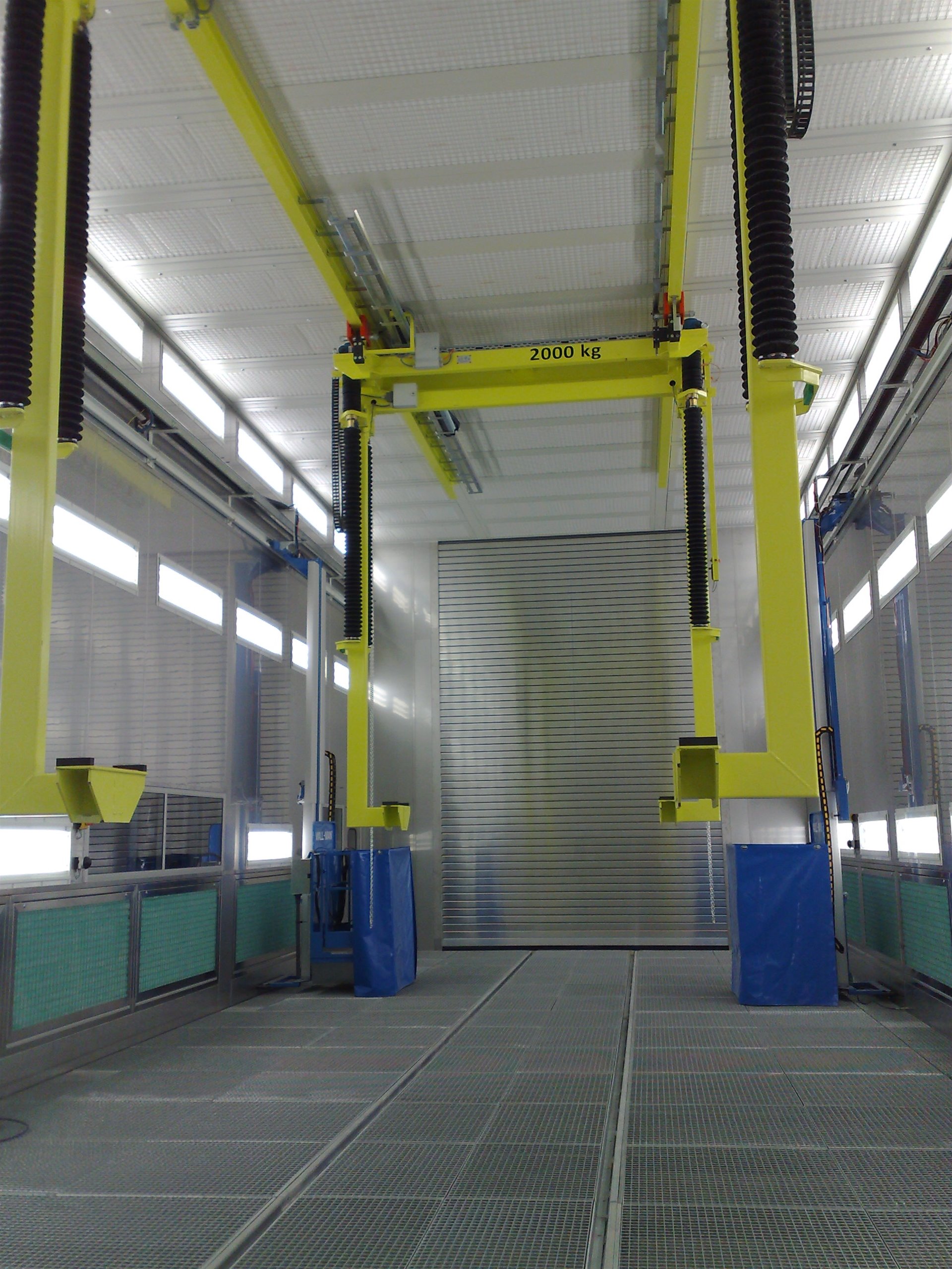 Automated lift system inside a processing or coating booth.